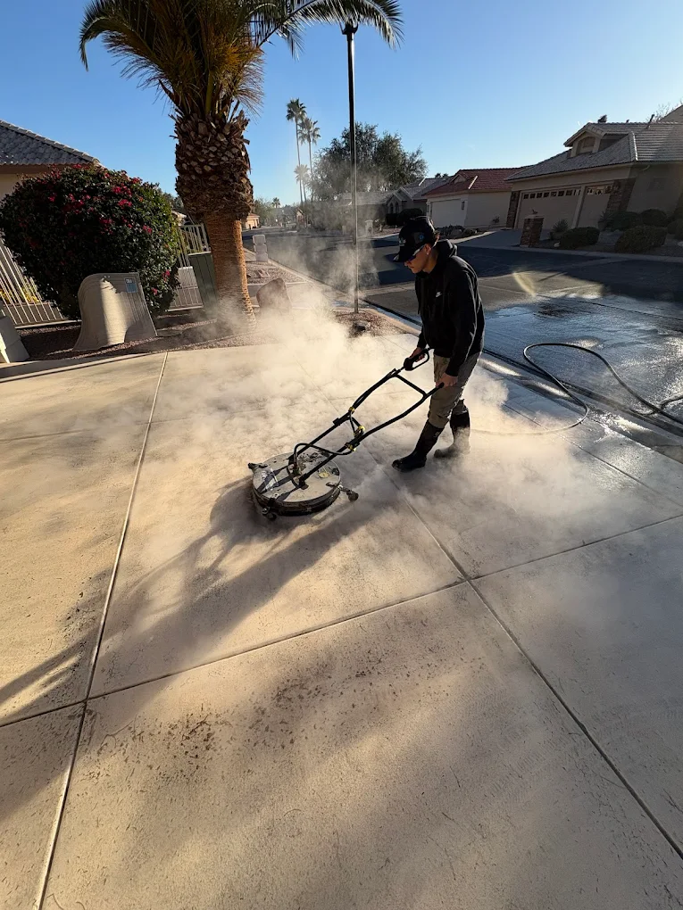 Commercial concrete surface cleaning with steam during daytime